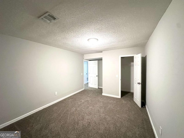 3170 W Point Cir, Douglasville, GA 30135 - unfurnished bedroom with baseboards, dark carpet, a textured ceiling, and a closet