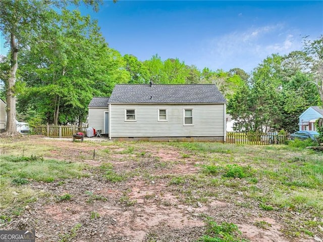 118 Greenwood St, Fairburn, GA 30213 - back of property featuring crawl space, view of wooded area, and roof with shingles