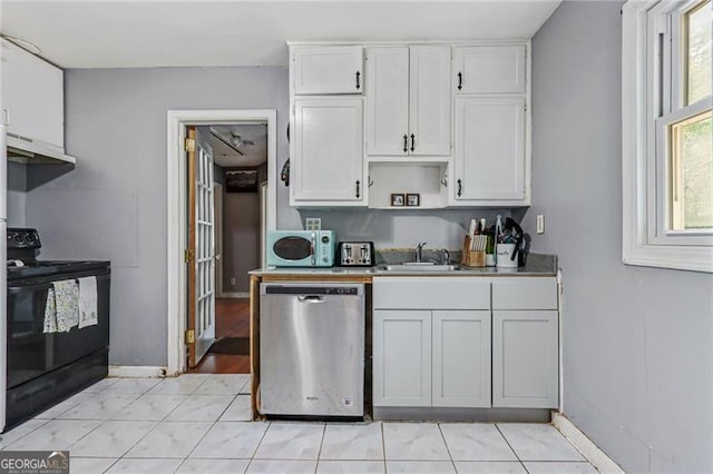118 Greenwood St, Fairburn, GA 30213 - kitchen with stainless steel dishwasher, black range with electric cooktop, a sink, white cabinets, and white microwave