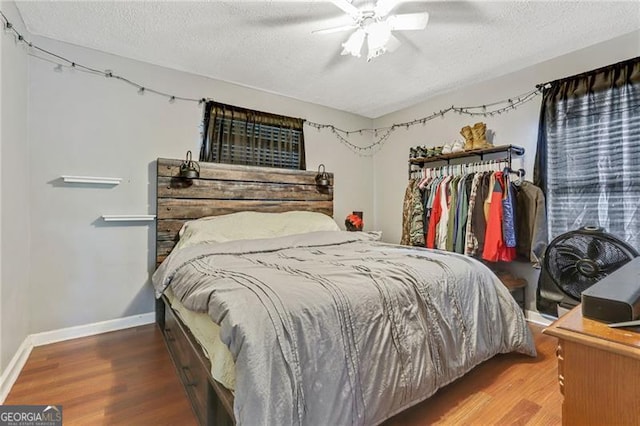 118 Greenwood St, Fairburn, GA 30213 - bedroom featuring wood finished floors, a textured ceiling, baseboards, and a ceiling fan