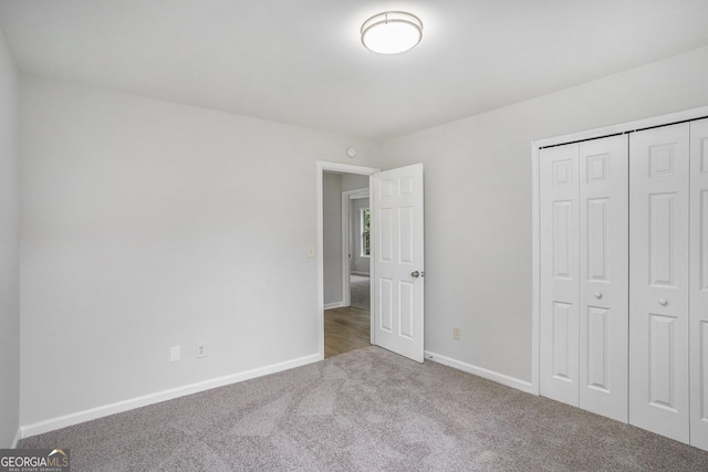 2681 Lakeside Dr SW, Conyers, GA 30094 - unfurnished bedroom featuring carpet flooring, baseboards, and a closet