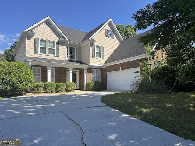 1031 Jordan Rd, Dacula, GA 30019 - traditional-style home featuring an attached garage, driveway, brick siding, and a front yard