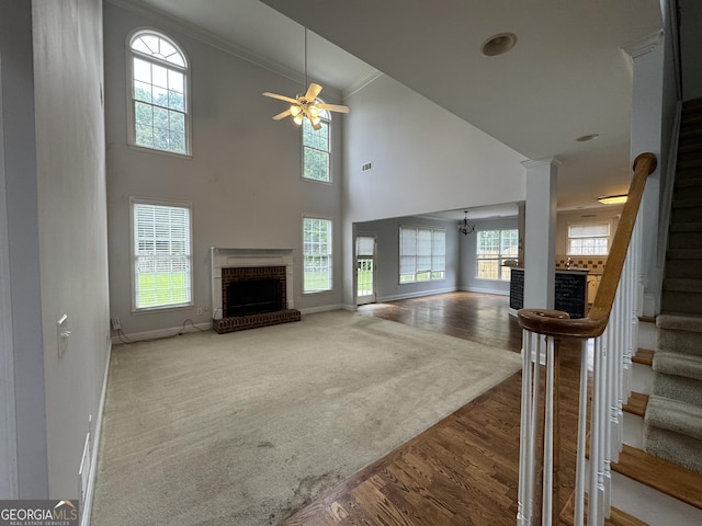 1031 Jordan Rd, Dacula, GA 30019 - living room with a fireplace, baseboards, stairway, a ceiling fan, and wood finished floors