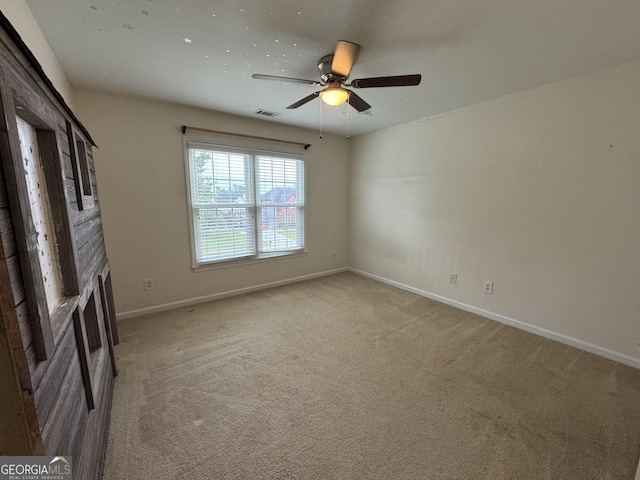 1031 Jordan Rd, Dacula, GA 30019 - spare room with ceiling fan, baseboards, light carpet, and a fireplace