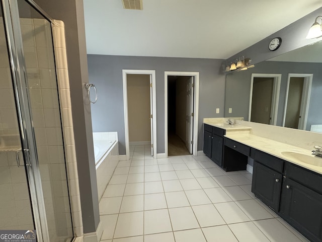 1031 Jordan Rd, Dacula, GA 30019 - bathroom with double vanity, a garden tub, a shower stall, tile patterned flooring, and baseboards