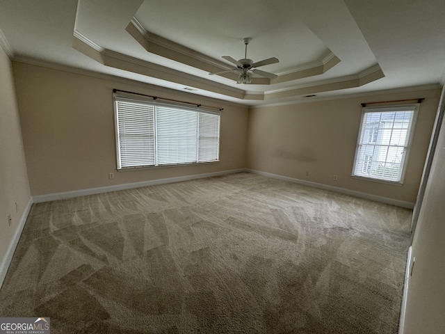1031 Jordan Rd, Dacula, GA 30019 - carpeted empty room with ornamental molding, a tray ceiling, ceiling fan, and baseboards