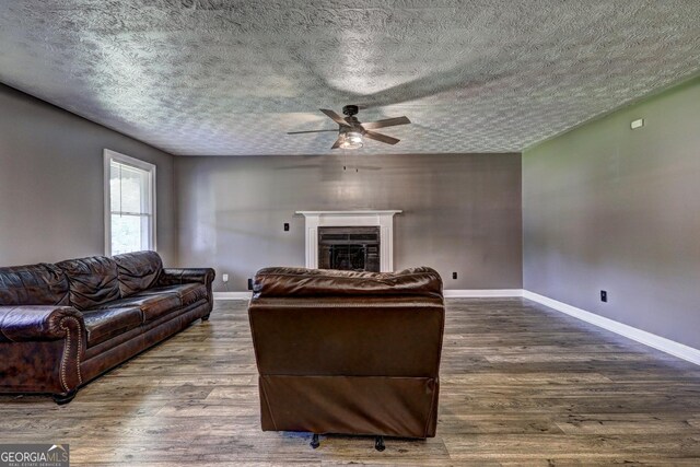 108 Country Acres Ct, Mcdonough, GA 30253 - living room featuring a ceiling fan, wood finished floors, a textured ceiling, and baseboards