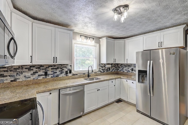 108 Country Acres Ct, Mcdonough, GA 30253 - kitchen featuring stainless steel appliances, a sink, backsplash, light tile patterned floors, and white cabinetry