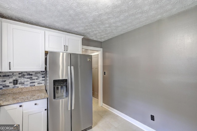 108 Country Acres Ct, Mcdonough, GA 30253 - kitchen featuring stainless steel fridge, decorative backsplash, white cabinetry, baseboards, and a textured ceiling