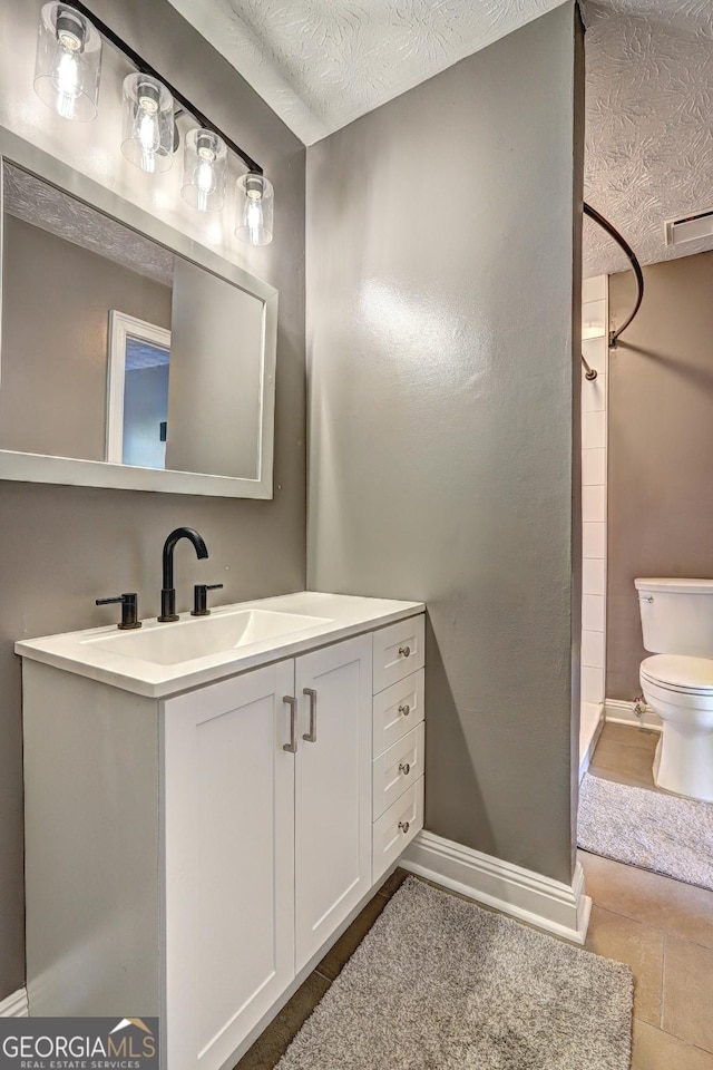 108 Country Acres Ct, Mcdonough, GA 30253 - full bathroom with toilet, a shower stall, vanity, a textured ceiling, and baseboards