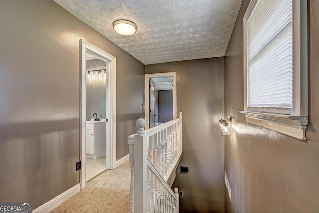 108 Country Acres Ct, Mcdonough, GA 30253 - hall with an upstairs landing, light colored carpet, a textured ceiling, and baseboards
