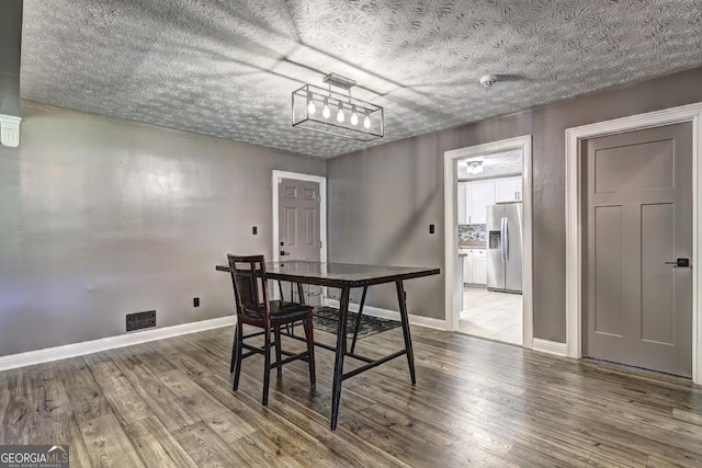 108 Country Acres Ct, Mcdonough, GA 30253 - dining space with wood finished floors, a textured ceiling, and baseboards