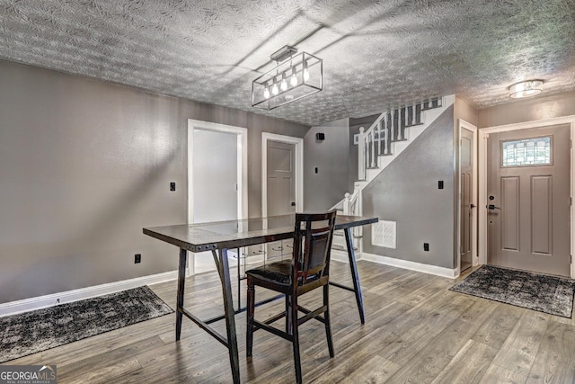 108 Country Acres Ct, Mcdonough, GA 30253 - dining space with baseboards, wood finished floors, stairs, and a textured ceiling