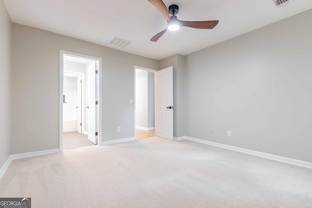 2012 Variations Dr NE, Atlanta, GA 30329 - unfurnished bedroom featuring light colored carpet, baseboards, connected bathroom, and a ceiling fan