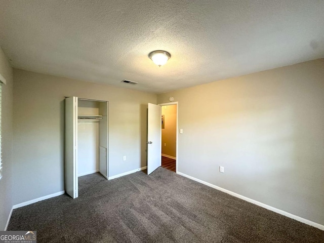 4039 Codel St NW, Atlanta, GA 30331 - unfurnished bedroom featuring dark carpet, a closet, baseboards, and a textured ceiling