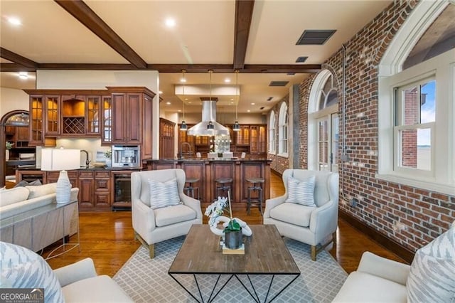 3180 Mathieson Dr NE Unit 1401, Atlanta, GA 30305 - living area with wood finished floors, brick wall, and beam ceiling