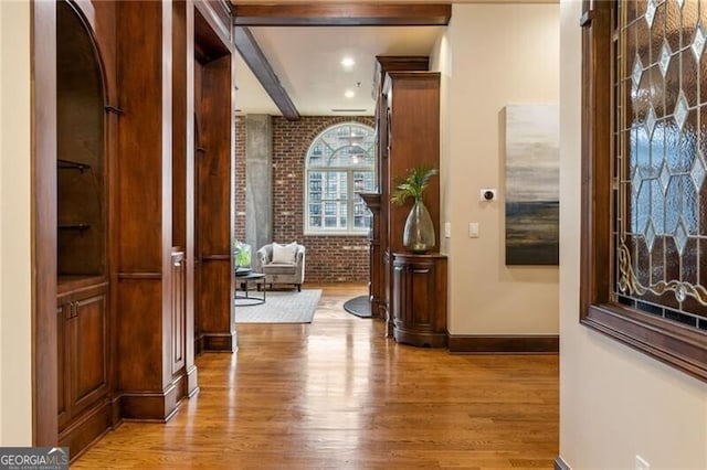 3180 Mathieson Dr NE Unit 1401, Atlanta, GA 30305 - hallway featuring brick wall, wood finished floors, and baseboards