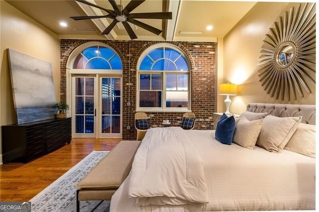 3180 Mathieson Dr NE Unit 1401, Atlanta, GA 30305 - bedroom with wood finished floors, brick wall, and beamed ceiling