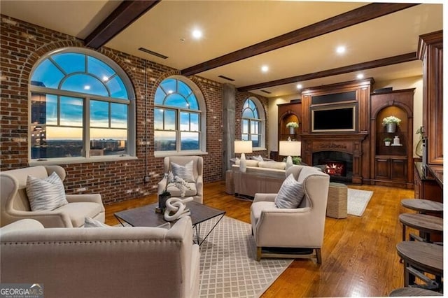 3180 Mathieson Dr NE Unit 1401, Atlanta, GA 30305 - living area featuring beam ceiling, a fireplace, wood finished floors, brick wall, and recessed lighting