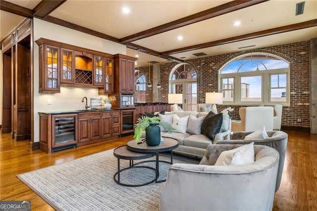 3180 Mathieson Dr NE Unit 1401, Atlanta, GA 30305 - living room with wine cooler, wood finished floors, beam ceiling, bar with sink, and brick wall