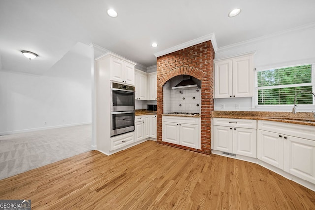 5190 Beech Forest Dr, Lilburn, GA 30047 - kitchen with a sink, stainless steel appliances, ornamental molding, white cabinets, and dark stone countertops