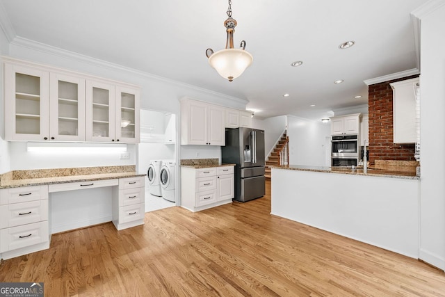 5190 Beech Forest Dr, Lilburn, GA 30047 - kitchen featuring stainless steel appliances, washing machine and clothes dryer, white cabinets, light wood-style flooring, and crown molding