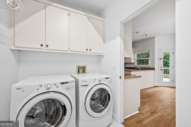 5190 Beech Forest Dr, Lilburn, GA 30047 - laundry area with washer and clothes dryer, cabinet space, light wood-style flooring, crown molding, and recessed lighting