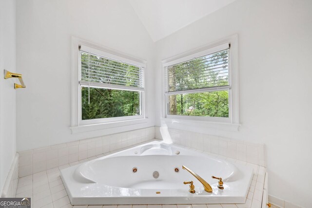 5190 Beech Forest Dr, Lilburn, GA 30047 - full bath with healthy amount of natural light, a tub with jets, and lofted ceiling