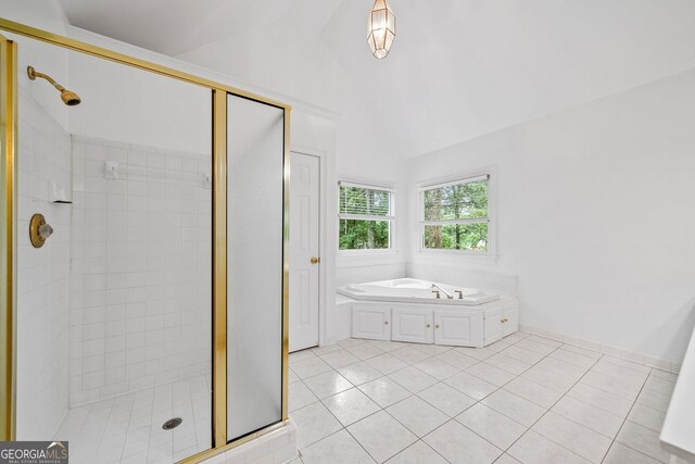 5190 Beech Forest Dr, Lilburn, GA 30047 - full bathroom featuring a shower stall, lofted ceiling, a bath, and tile patterned floors