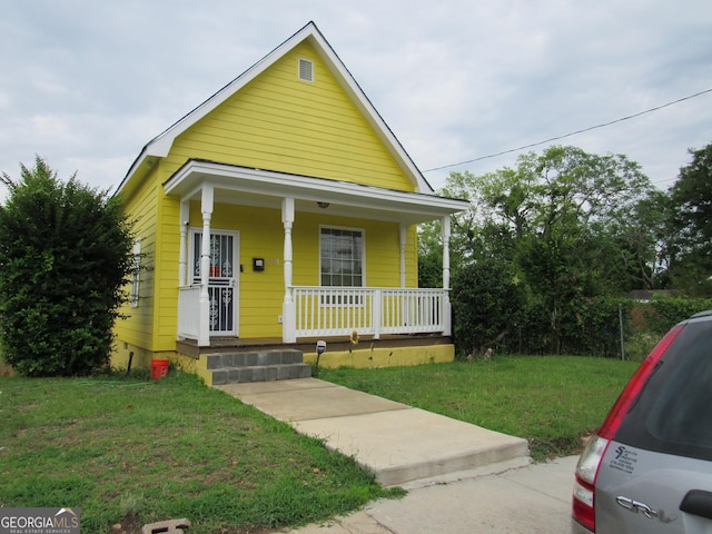 791 Anderson St, Macon, GA 31201 - shotgun-style home featuring a porch and a front lawn