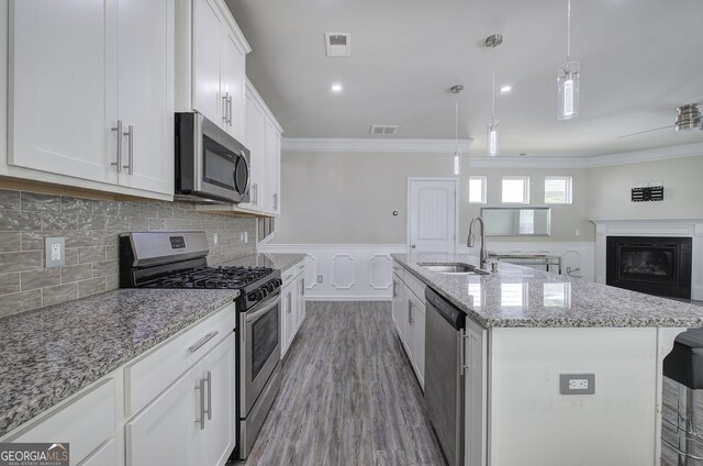 158 Bryon Ln, Acworth, GA 30102 - kitchen featuring stainless steel appliances, a sink, crown molding, white cabinetry, and an island with sink