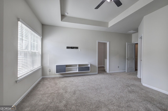 158 Bryon Ln, Acworth, GA 30102 - unfurnished living room featuring carpet floors, a raised ceiling, ceiling fan, and baseboards