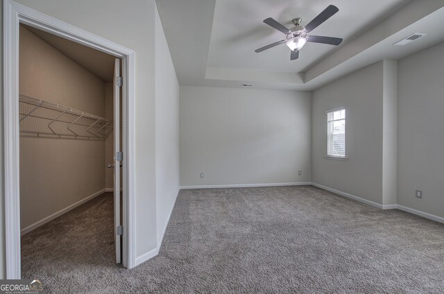 158 Bryon Ln, Acworth, GA 30102 - unfurnished bedroom with carpet, a spacious closet, baseboards, and a tray ceiling