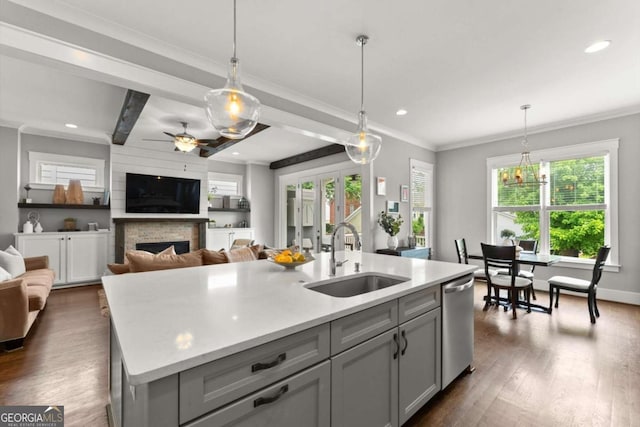 1104 Victoria St NE, Atlanta, GA 30319 - kitchen featuring a sink, dishwasher, gray cabinetry, light countertops, and a fireplace