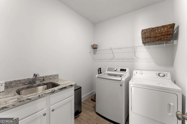 1104 Victoria St NE, Atlanta, GA 30319 - washroom with independent washer and dryer, wood finished floors, cabinet space, and baseboards
