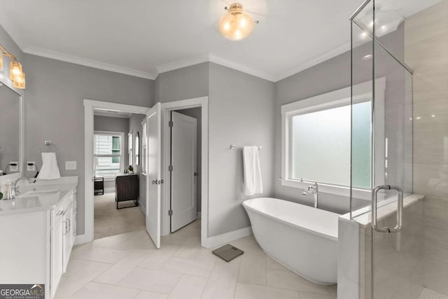 1104 Victoria St NE, Atlanta, GA 30319 - bathroom with vanity, a freestanding bath, a stall shower, ornamental molding, and baseboards