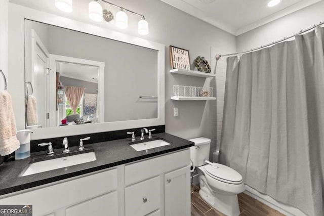 1104 Victoria St NE, Atlanta, GA 30319 - full bath with double vanity, wood finished floors, toilet, and ornamental molding