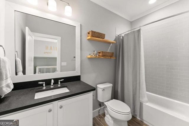 1104 Victoria St NE, Atlanta, GA 30319 - full bath with vanity, toilet, wood finished floors, shower / tub combo with curtain, and crown molding