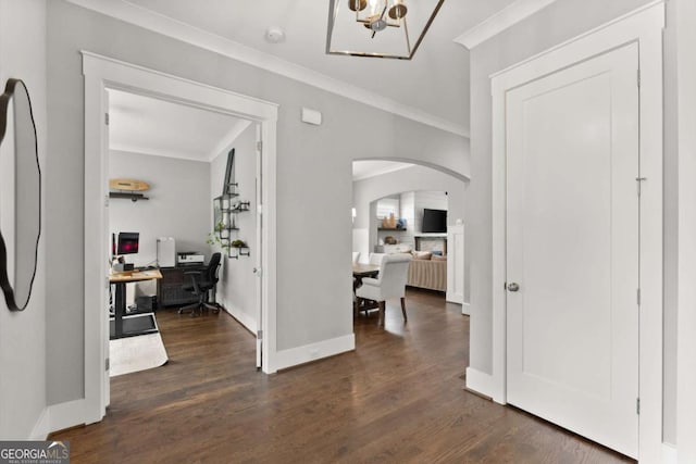 1104 Victoria St NE, Atlanta, GA 30319 - foyer featuring arched walkways, crown molding, a chandelier, dark wood-type flooring, and baseboards