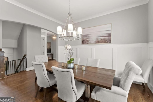 1104 Victoria St NE, Atlanta, GA 30319 - dining room featuring a chandelier, dark wood-type flooring, crown molding, wainscoting, and arched walkways