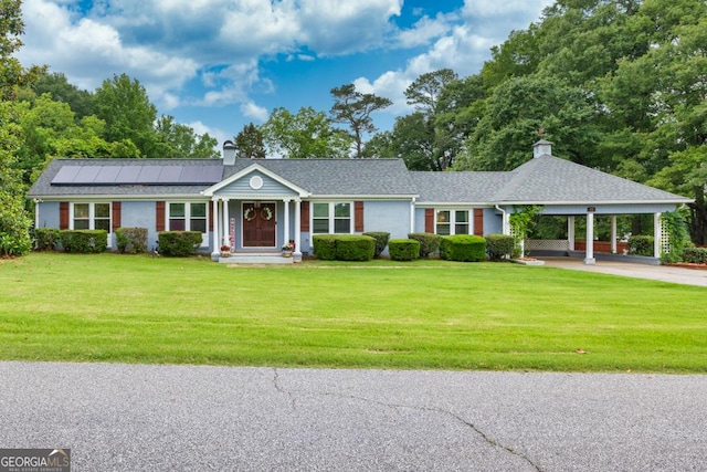 75 E 2nd Ave, Colbert, GA 30628 - ranch-style home with a chimney, a front lawn, solar panels, a carport, and driveway