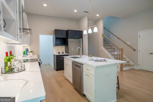 4366 Bradley Dr SW, Snellville, GA 30039 - kitchen with stainless steel appliances, a sink, light wood finished floors, light stone counters, and glass insert cabinets