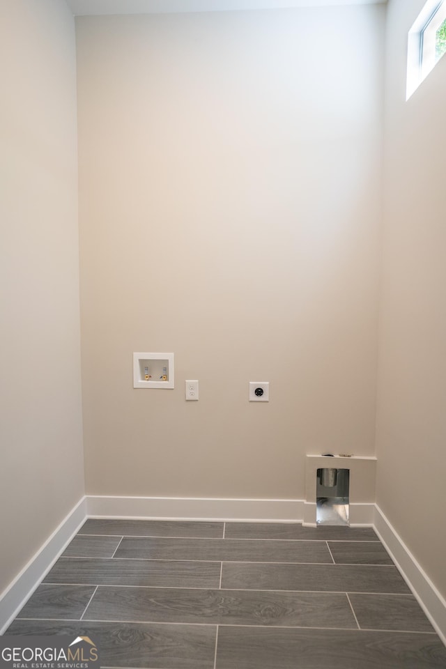 4366 Bradley Dr SW, Snellville, GA 30039 - laundry room with electric dryer hookup, hookup for a washing machine, baseboards, and dark wood-style floors