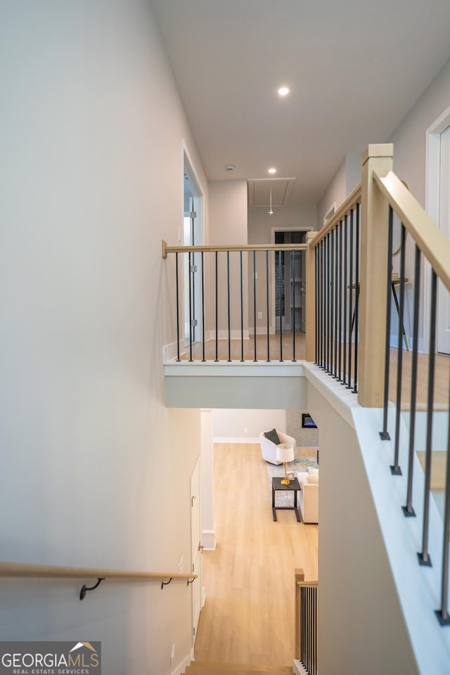 4366 Bradley Dr SW, Snellville, GA 30039 - staircase with attic access, wood finished floors, and recessed lighting