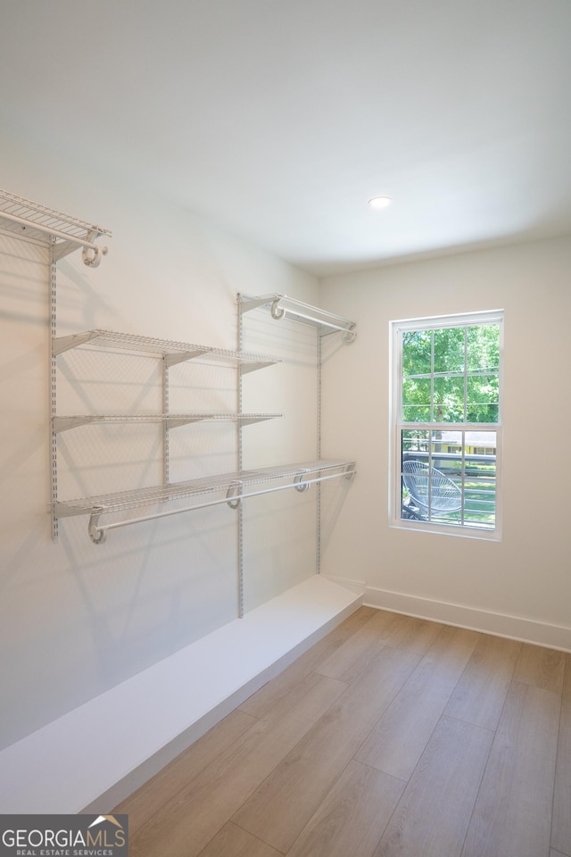 4366 Bradley Dr SW, Snellville, GA 30039 - walk in closet featuring wood finished floors