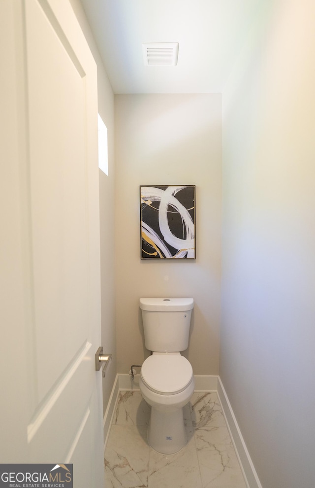 4366 Bradley Dr SW, Snellville, GA 30039 - bathroom with marble look tiles, baseboards, and toilet