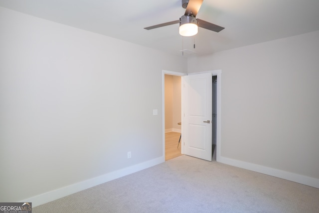 4366 Bradley Dr SW, Snellville, GA 30039 - unfurnished room with light colored carpet, a ceiling fan, and baseboards