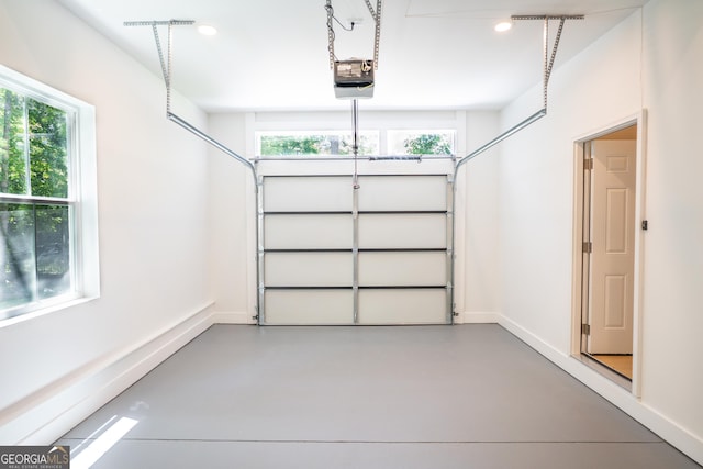 4366 Bradley Dr SW, Snellville, GA 30039 - garage featuring a garage door opener, baseboards, and recessed lighting