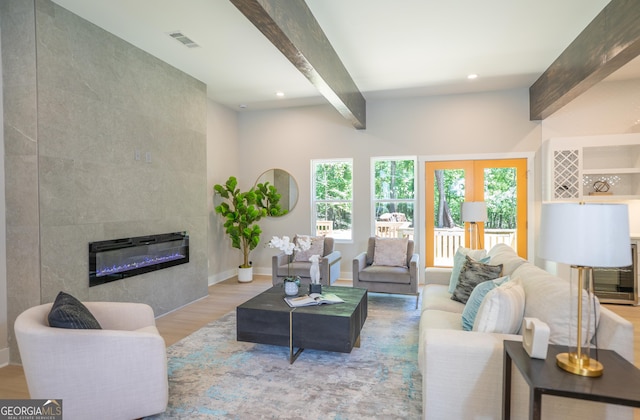 4366 Bradley Dr SW, Snellville, GA 30039 - living area featuring beam ceiling, plenty of natural light, wood finished floors, a tiled fireplace, and recessed lighting