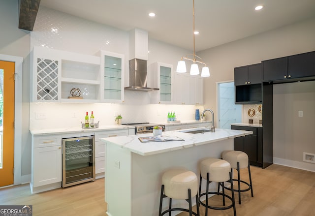 4366 Bradley Dr SW, Snellville, GA 30039 - kitchen featuring beverage cooler, light wood-style floors, stainless steel electric stove, wall chimney exhaust hood, and decorative backsplash